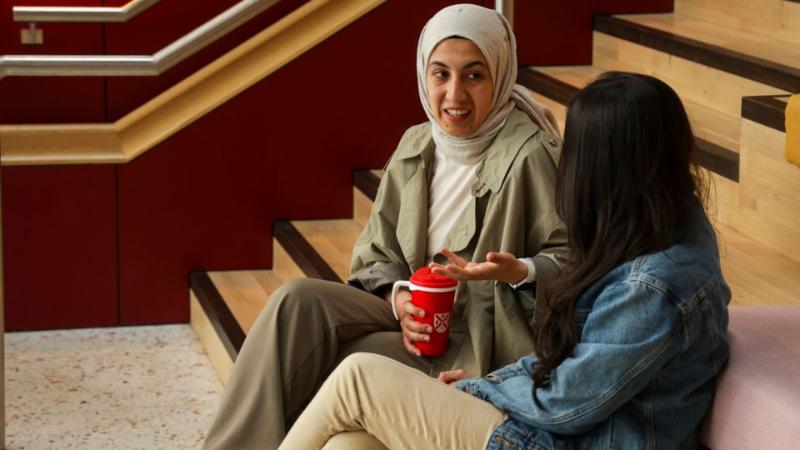 student sitting on staircase talking